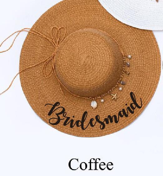 Brown floppy hat with bridesmaid written in black and shell charms.