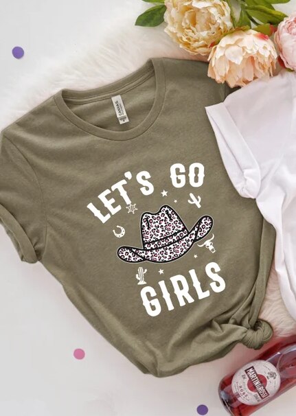 Green t-shirt with let's go girls written in white and a cowboy hat on the front.