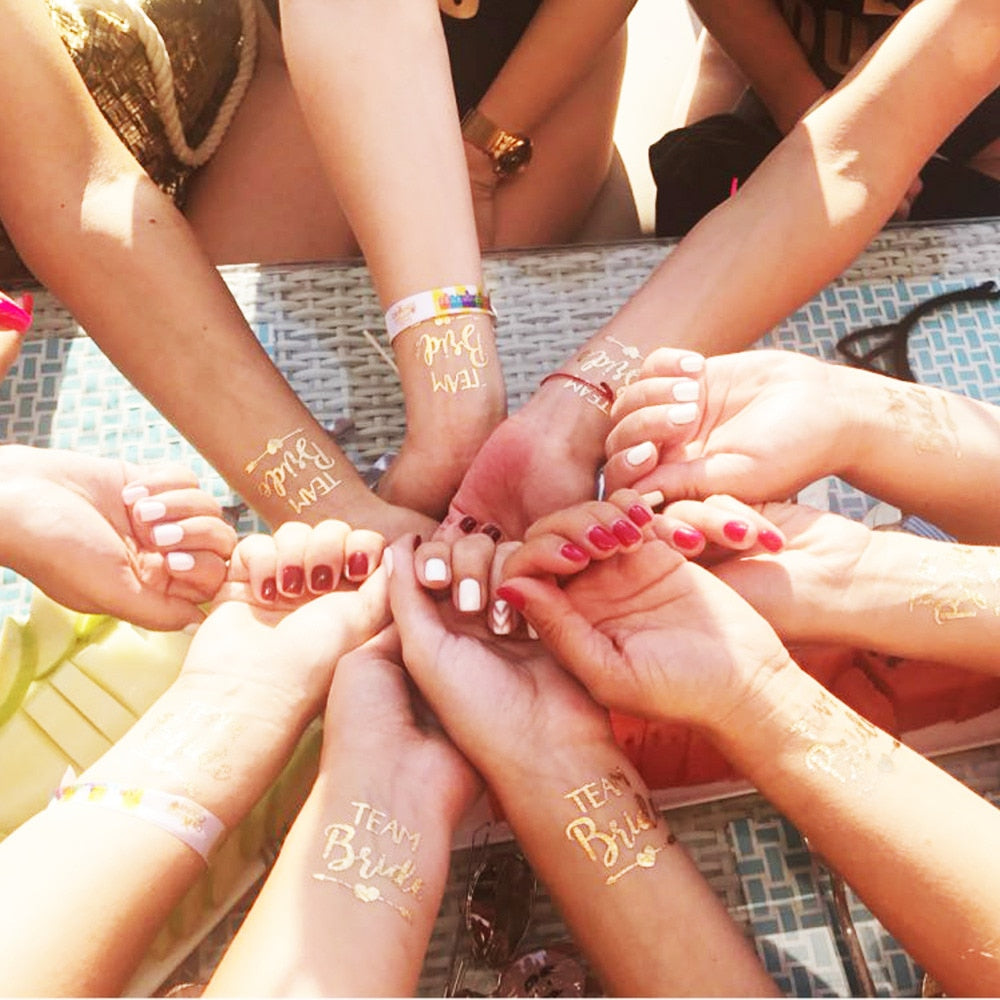 Macro shot of temporary tattoo of a ring on bridesmaids hands held  together. Cheerful bride and bridesmaids party before wedding. Women having  fun Stock Photo - Alamy