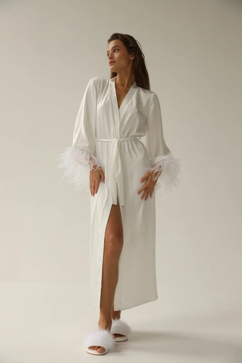 White floor length robe with feathered sleeves