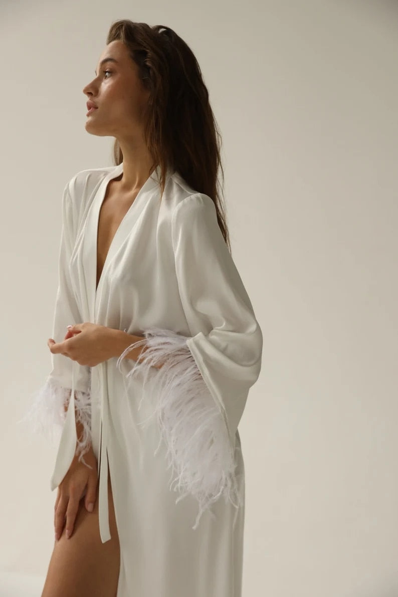 White floor length robe with feathered sleeves